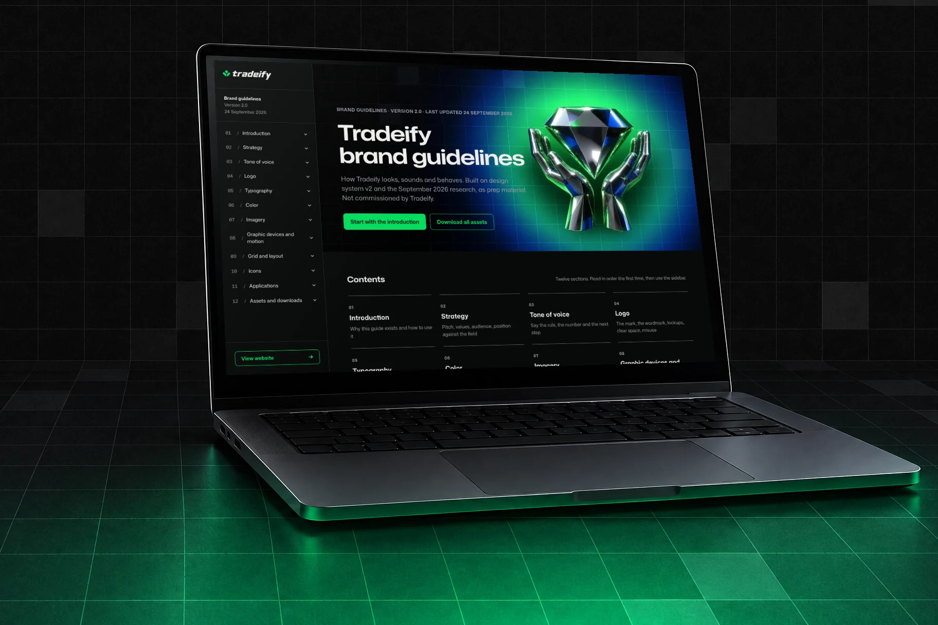 The Tradeify brand guidelines home open on a laptop in a dark room with a lit grid floor
